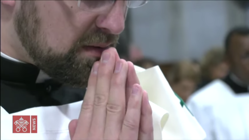 Deacon Tom Skaja in prayer during the Eucharistic Prayer.
