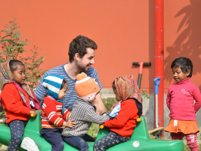 seminarian john utecht plays with children during a mission trip.